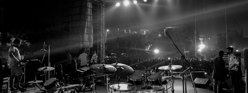 Concert stage with dramatic lighting and performers